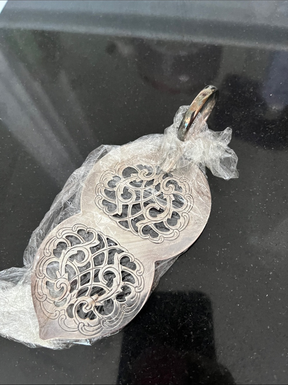 Vintage silver-plated cake server with finger loop.